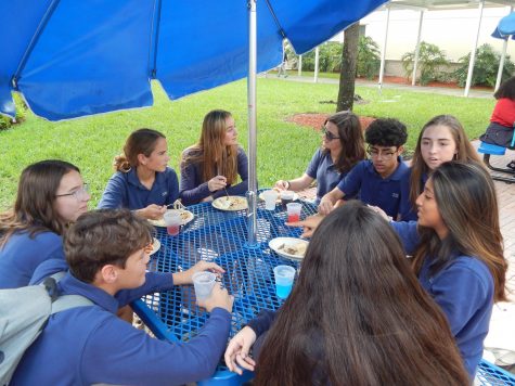 A group of friends enjoy their twenty-five minute lunch break over the new school lunch program, Sage Dining.