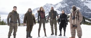 (Lest to Right) Nick Jonas, Jack Black, Karen Gillan, Dwayne Johnson, Awkwafina, and Kevin Hart stand in Jumanji's icy tundra before trying to penetrate Jurgan the Brutal's fortress. Unless they can stop him, Jumanji will be a lifeless wasteland forever. (Photo Credit: rogerebert.com)
