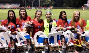 The senior girls receive their senior baskets after celebrating the victory of the game. (Photo Credit: Janice Rinker)