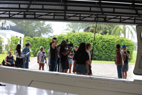 the crew is filming in a hangar